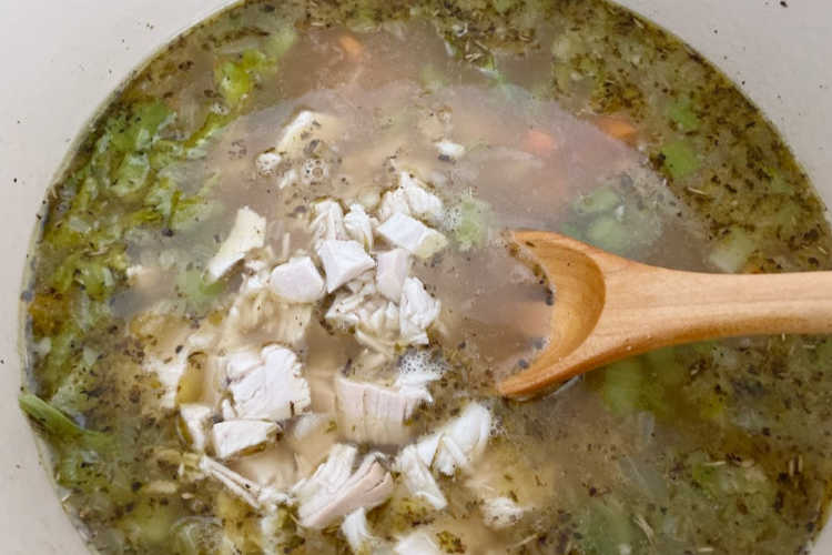 add leftover cooked turkey to turkey soup in dutch oven