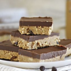 no bake chocolate peanut butter bars stacked on a white plate