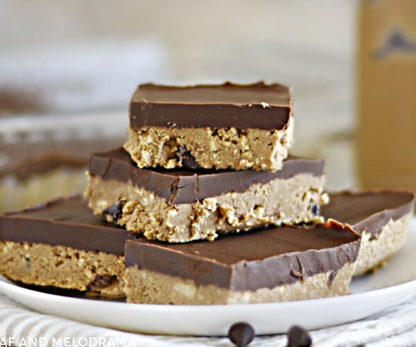 no bake chocolate peanut butter bars stacked on a white plate