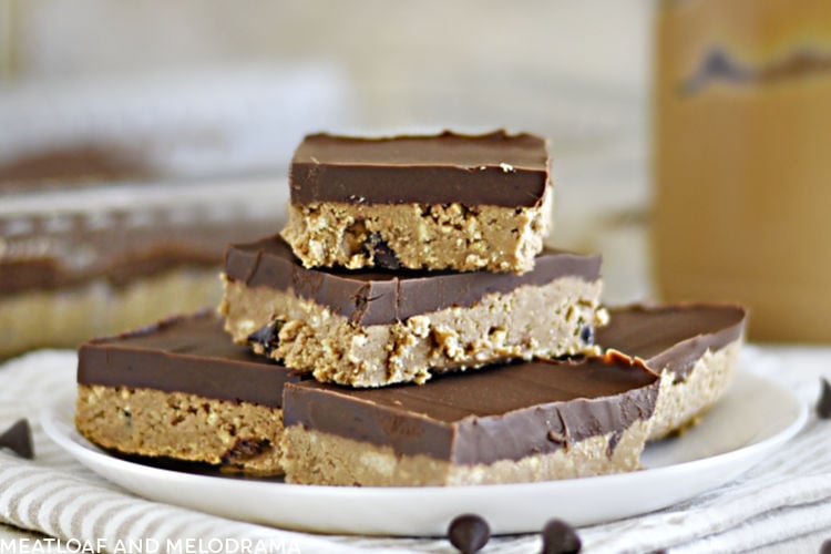 no bake chocolate peanut butter bars stacked on a white plate