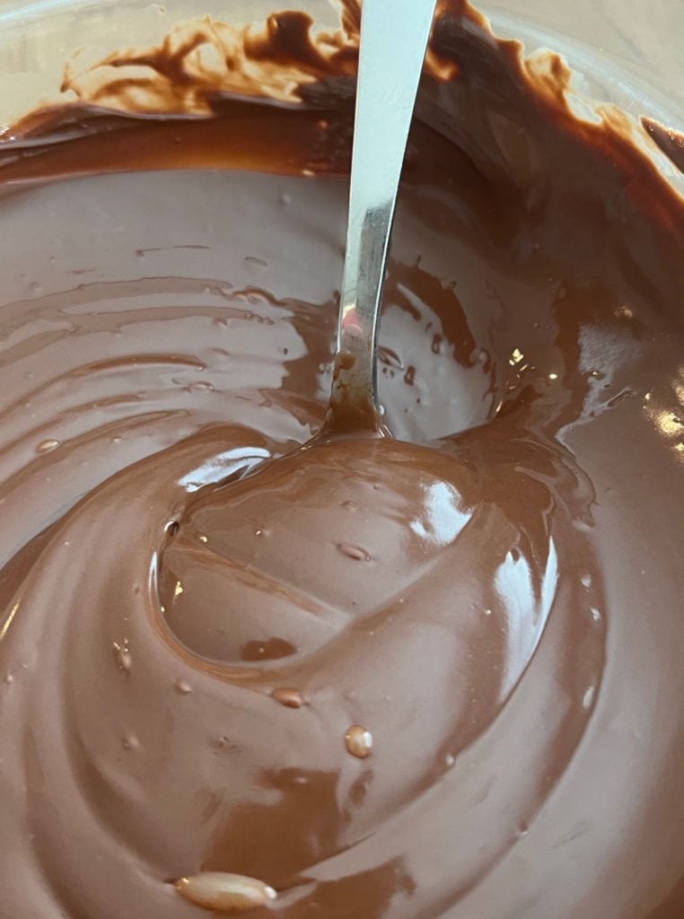 stir melted chocolate chips with spoon in mixing bowl