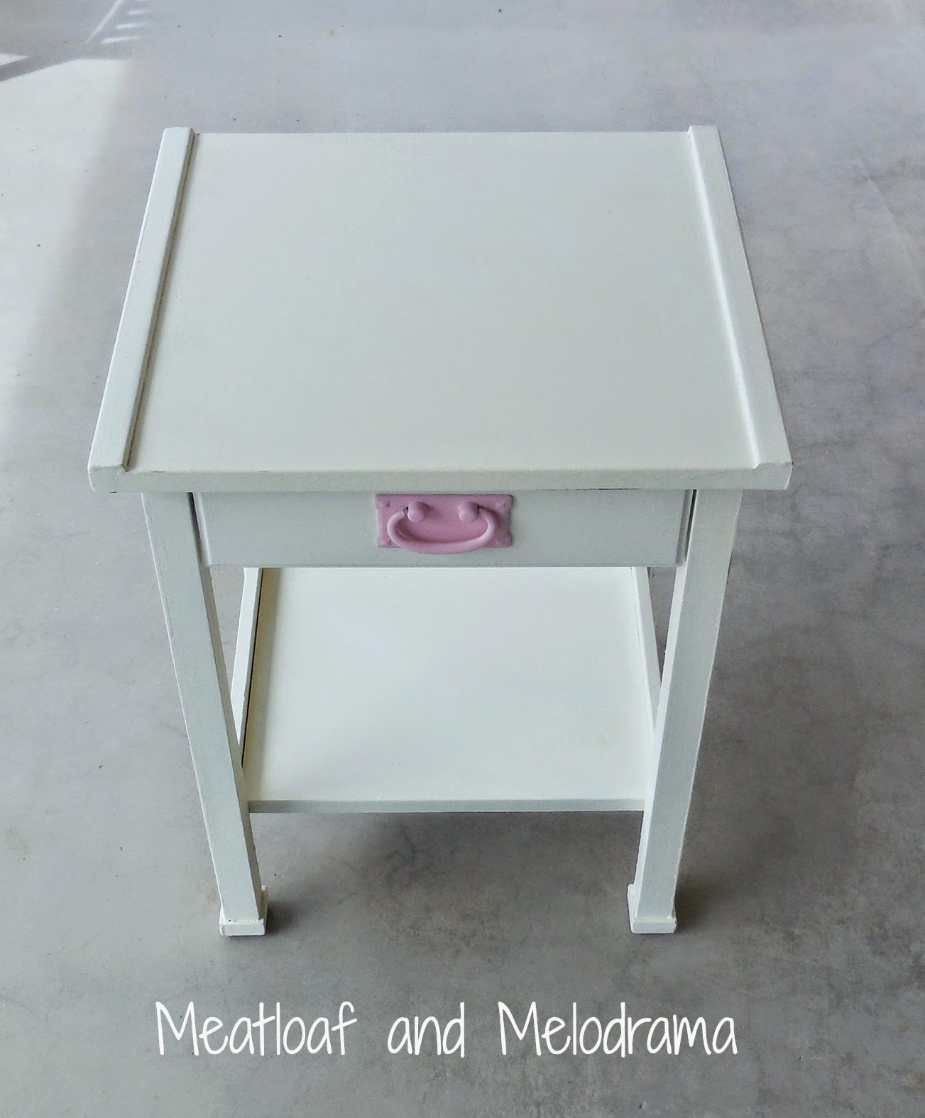 pink and white laminate side table painted with white latex chalk paint