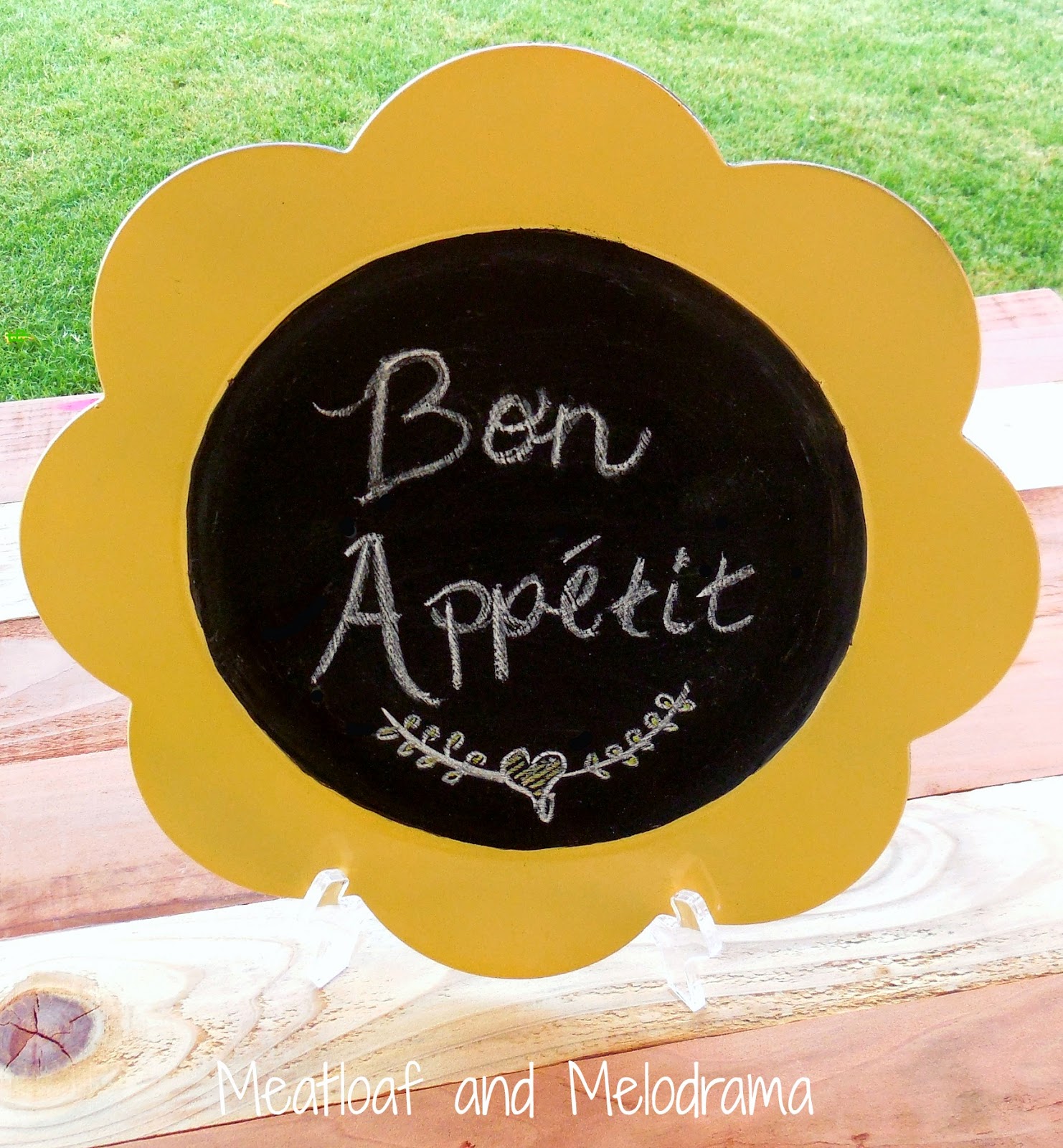yellow and black sunflower chalkboard charger on picnic table