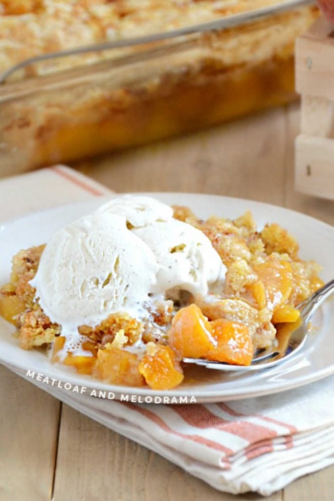 peach dump cake with vanilla ice cream on top