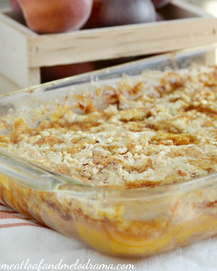 baked peach cobbler with cake mix topping in a 9 x 13 pan