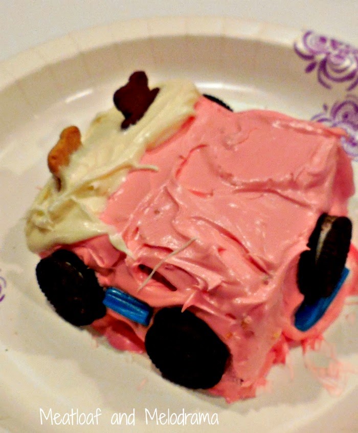 pink jeep made from cake with pink frosting, teddy grahams, twizzlers and oreo cookies