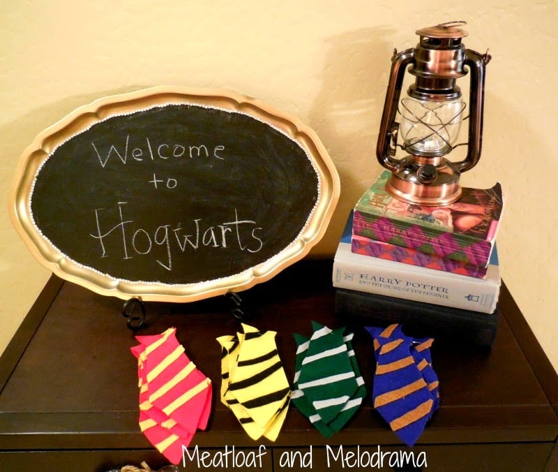 chalkboard welcome to hogwarts sign with harry potter books, lantern and  felt ties