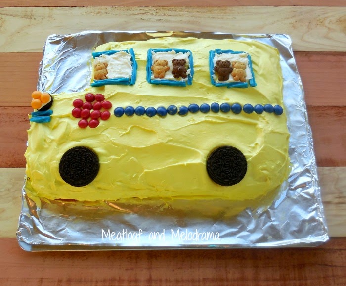 yellow school bus cake with skittles, twizzlers, oreo cookies and teddy grahams for back to school