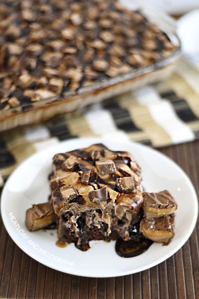 milky way poke cake and slice of cake on a white plate