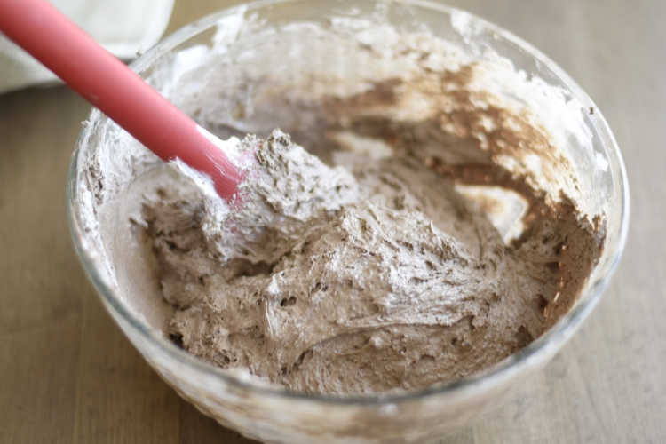 mix cool whip and cake mix in glass mixing bowl