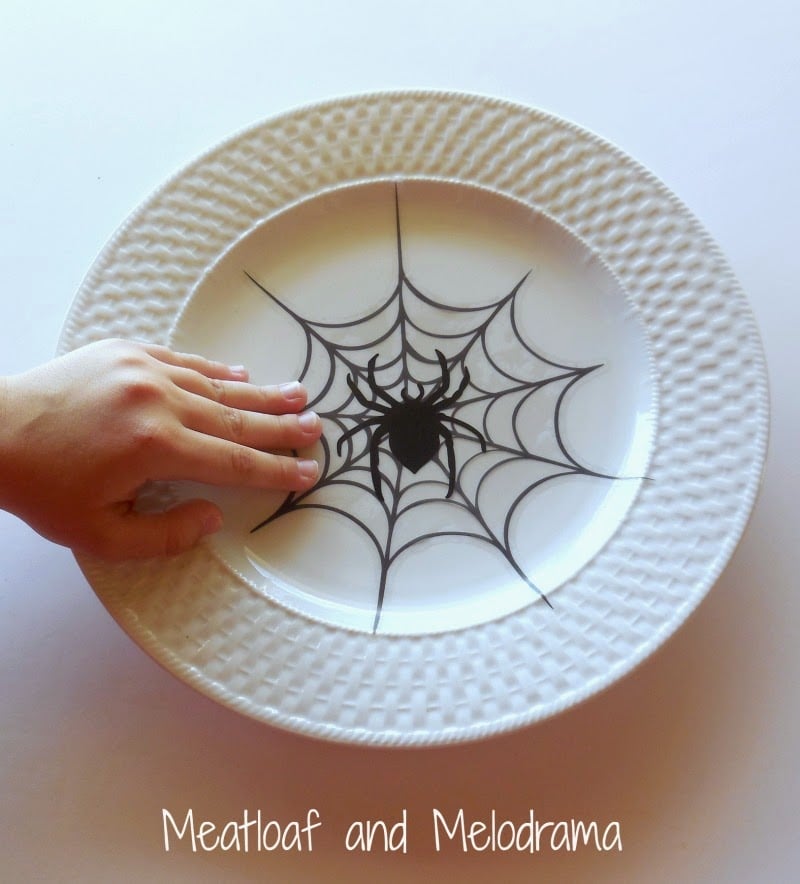 smooth window cling on center of white plate to make halloween plates 