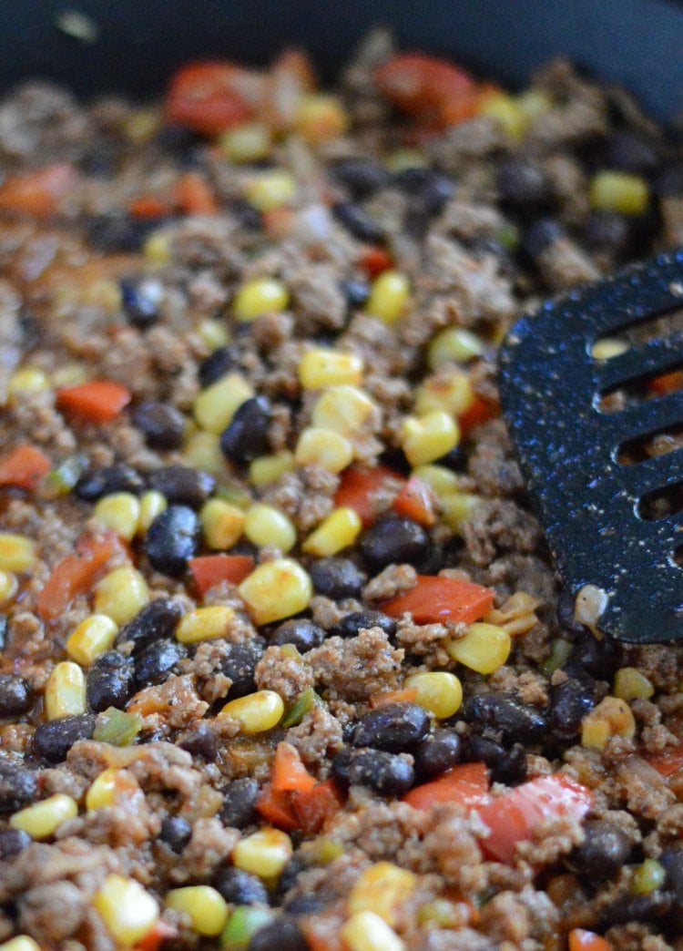 brown ground beef corn black beans and peppers for southwestern lasagna casserole