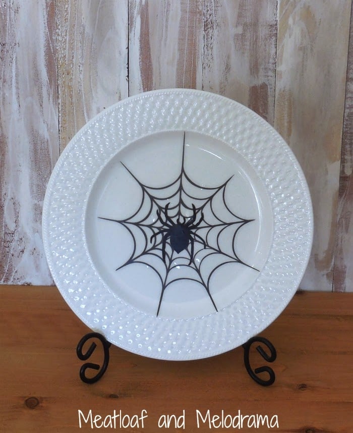 white dinner plate with black spider and spider web design from window clings 