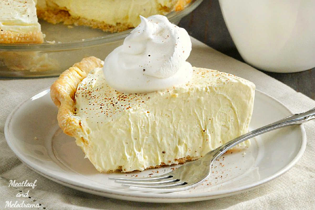 slice of eggnog pie on a plate with cool whip