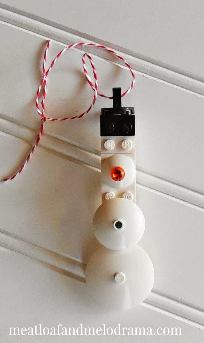 snowman made from legos with red and white twine to hang on tree 