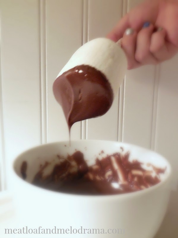 dip jumbo marshmallow into bowl of melted chocolate