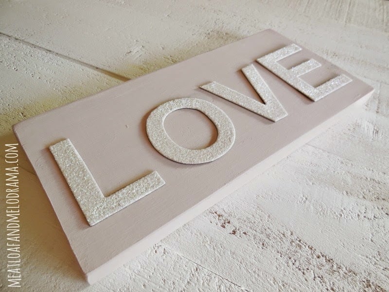 use white cardboard letters to spell love on sign