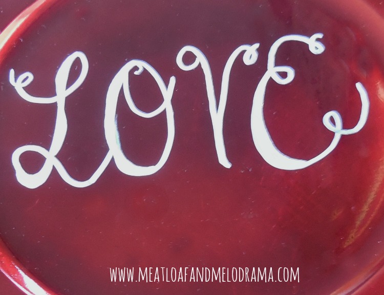 calligraphy love on red charger plate