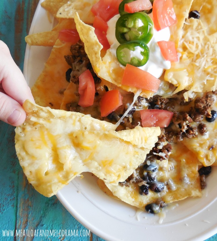 nacho chips with shredded cheese and beef and beans