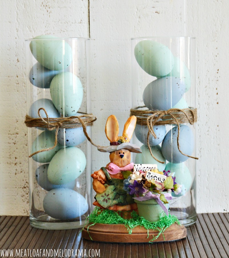 painted plastic blue eggs in tall glass vases