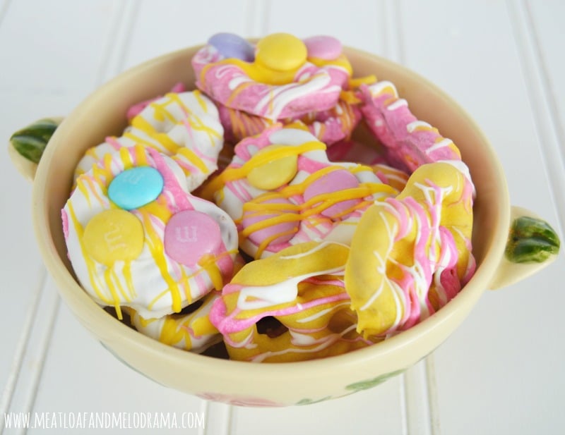 pink and yellow and white candy coated pretzels made with wilton candy melts