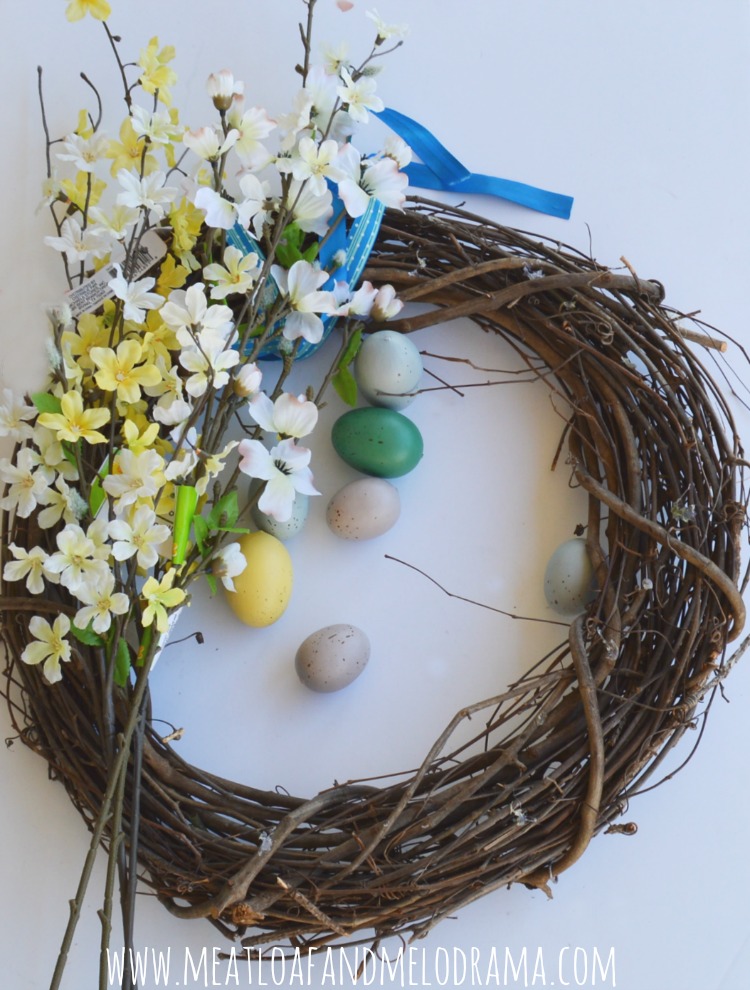 faux flowers pussy willow branches and faux eggs and grapevine wreath