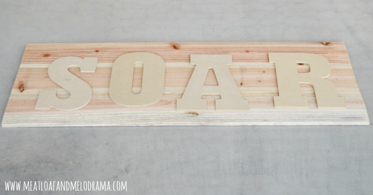 chipboard letters on a wood background