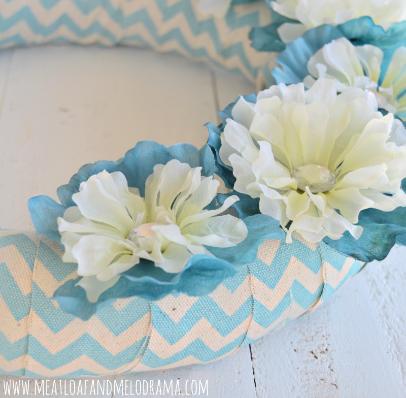 teal and white flowers with clear stones on chevron wreath