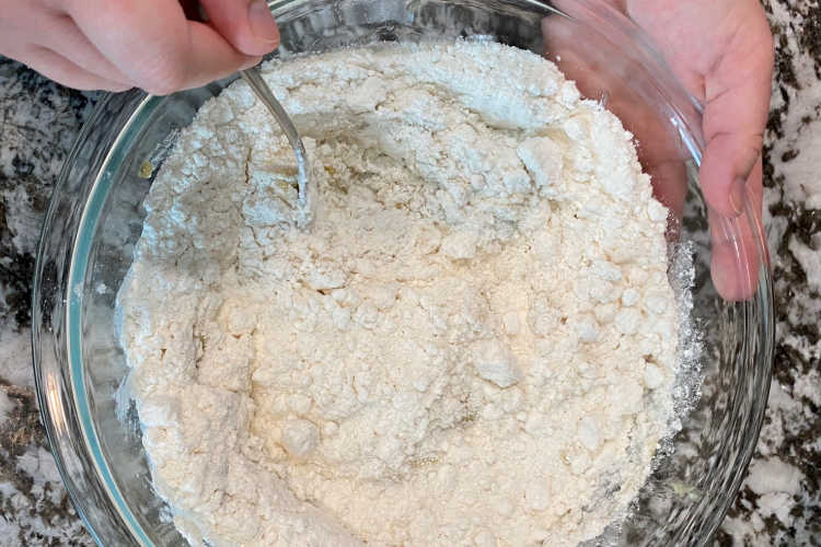 mix cake mix with bananas in bowl