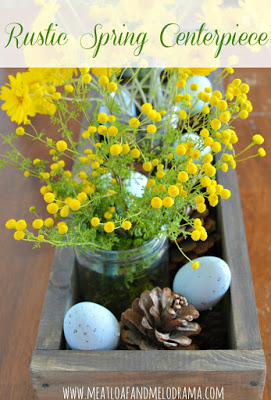 rustic spring centerpiece with flowers and blue eggs