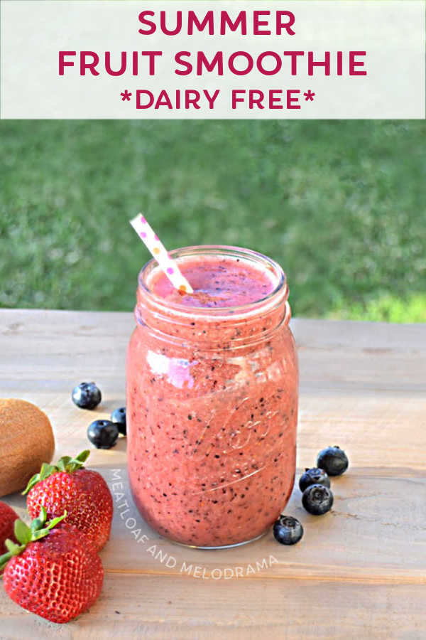 summer fruit smoothie in a glass on a picnic table with fresh fruit and strraw