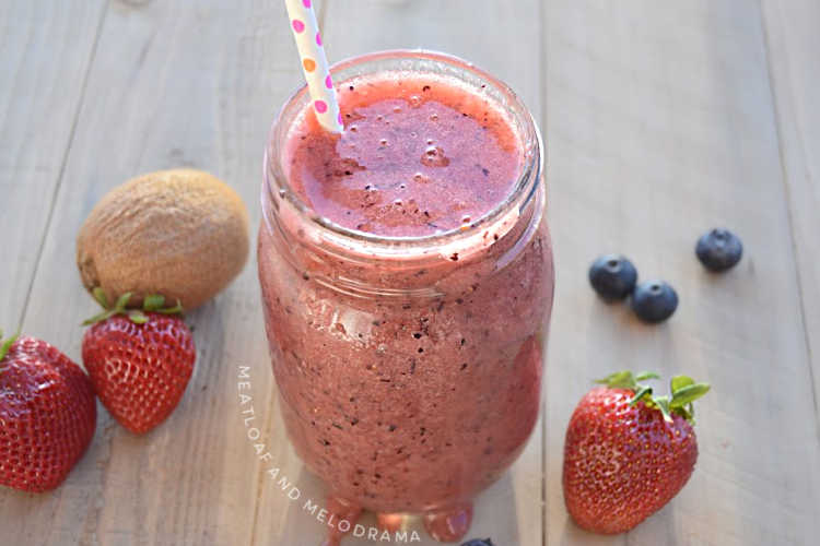 mixed berry fruit smoothie in jar with strawberries blueberries and kiwi with 