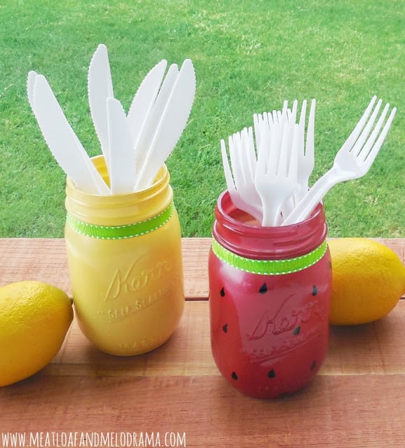 lemon and watermelon mason jars holding forks and knives 