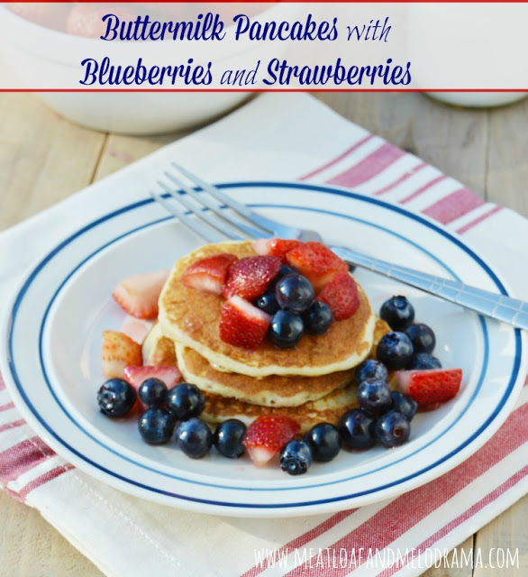 stack of pancakes topped with strawberries and blueberries for Fourth of July