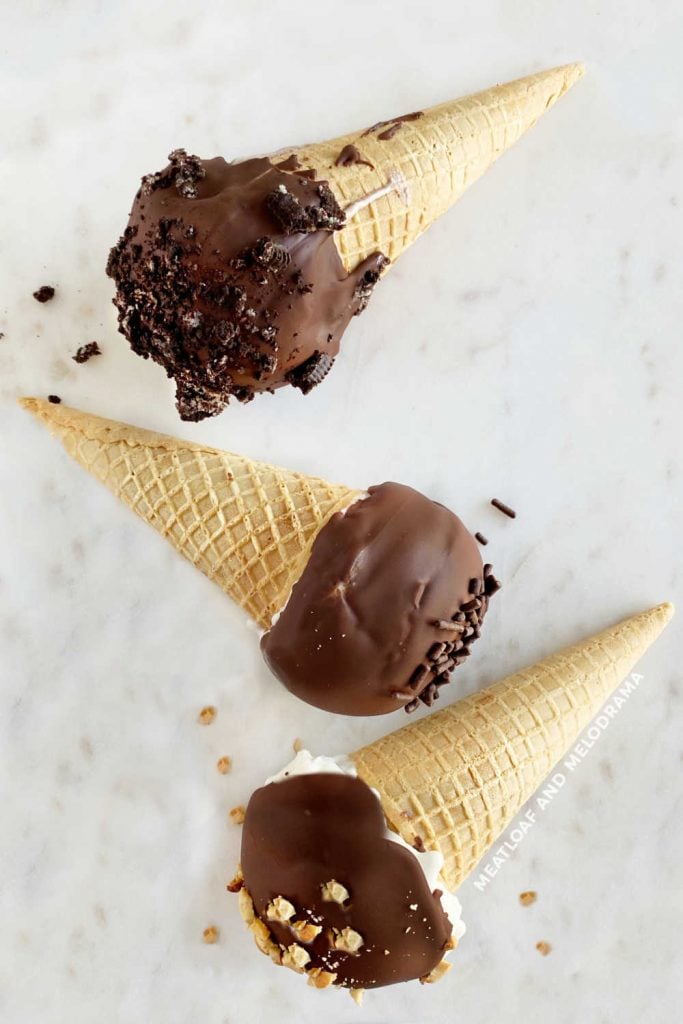 homemade drumstick ice cream cones with chocolate shell on marble surface