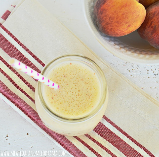 peach smoothie in a mason jar with straw