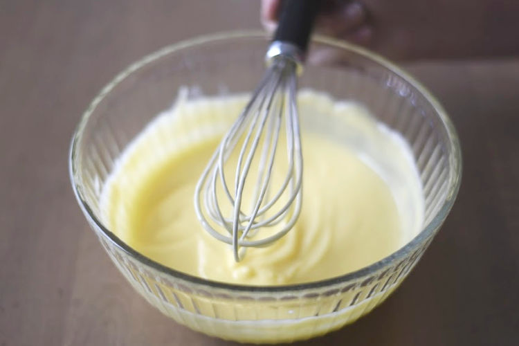 bowl of instant vanilla jello pudding with whisk