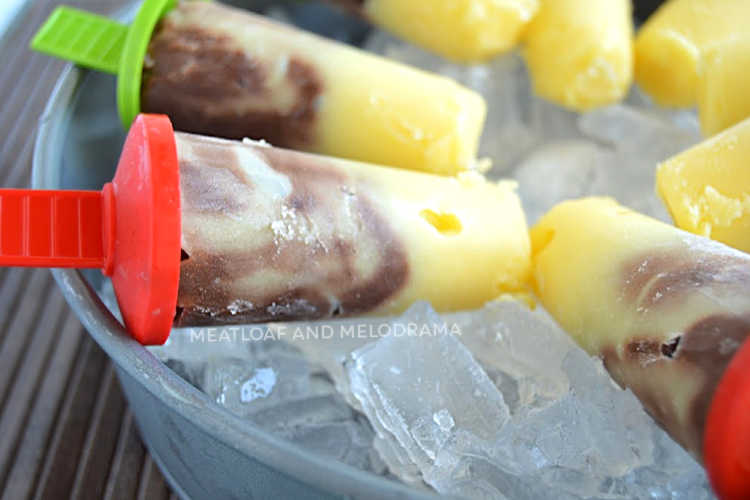 swirled vanilla and chocolate jello pudding pops on ice in a bowl