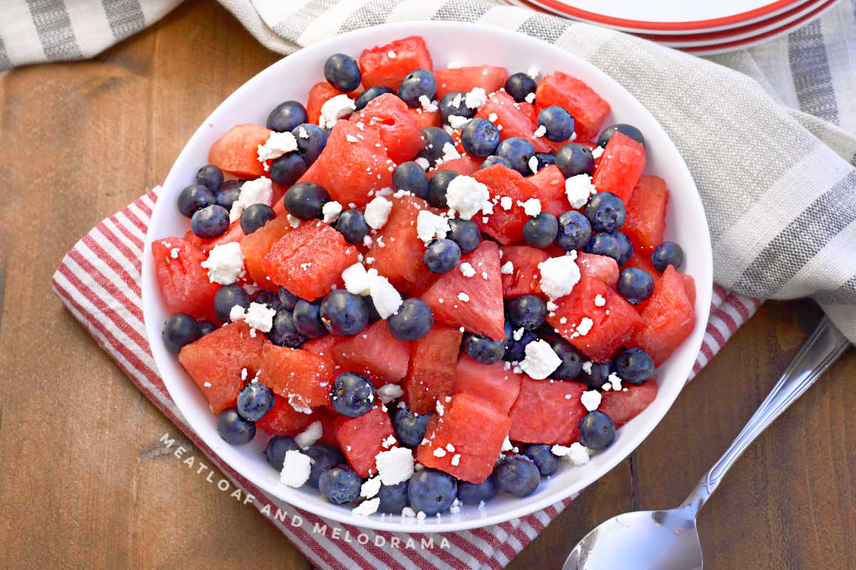 watermelon, feta and blueberry salad in white serving bowl