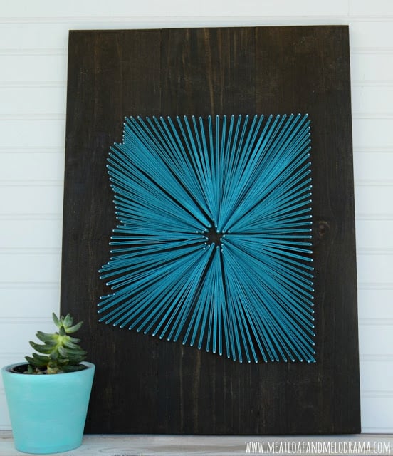 Arizona string art made with aqua string on dark wood background