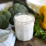 homemade buttermilk ranch dressing in a jar with raw veggies