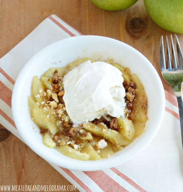 single serving apple crisp in a bowl topped with ice cream