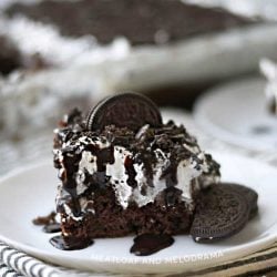 oreo poke cake with oreo cookies on white plate