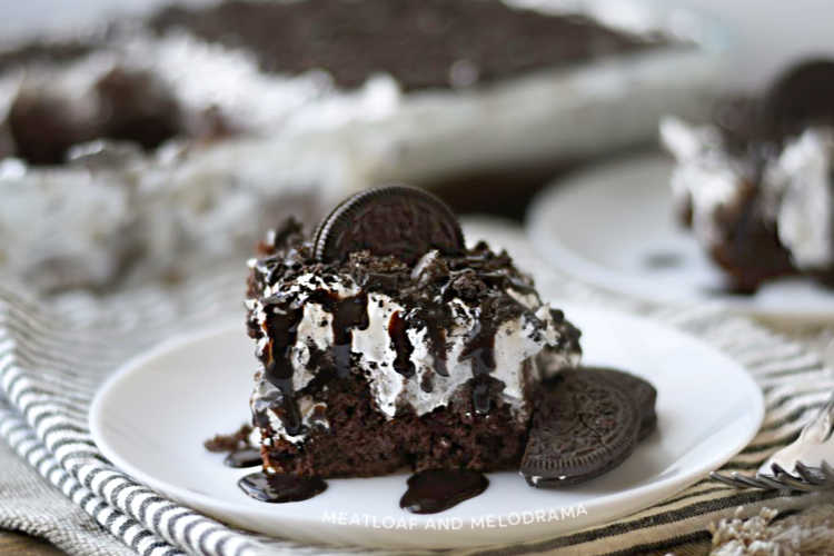 oreo poke cake with oreo cookies on white plate