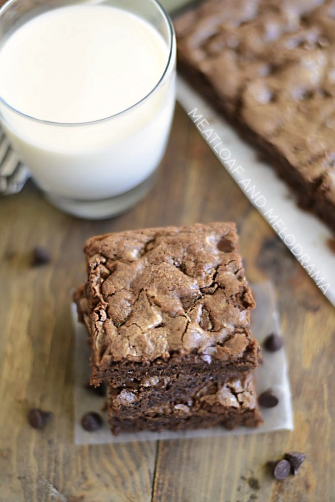 stack of thick double chocolate brownies with glass of milk
