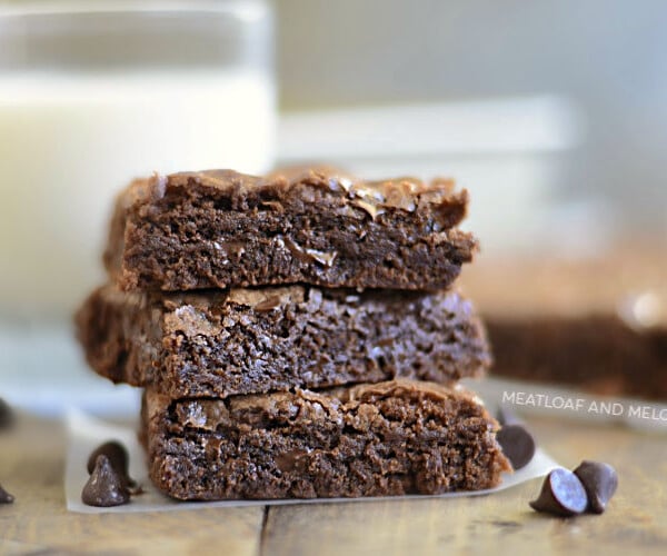 three fudgy chewy double chocolate brownies with chocolate chips brownies stacked