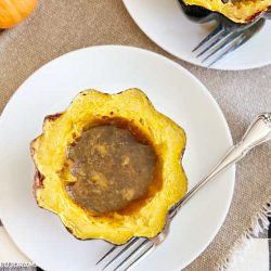 baked acorn squash with brown sugar and maple syrup on plate