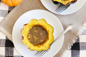 baked acorn squash with brown sugar and maple syrup on plate