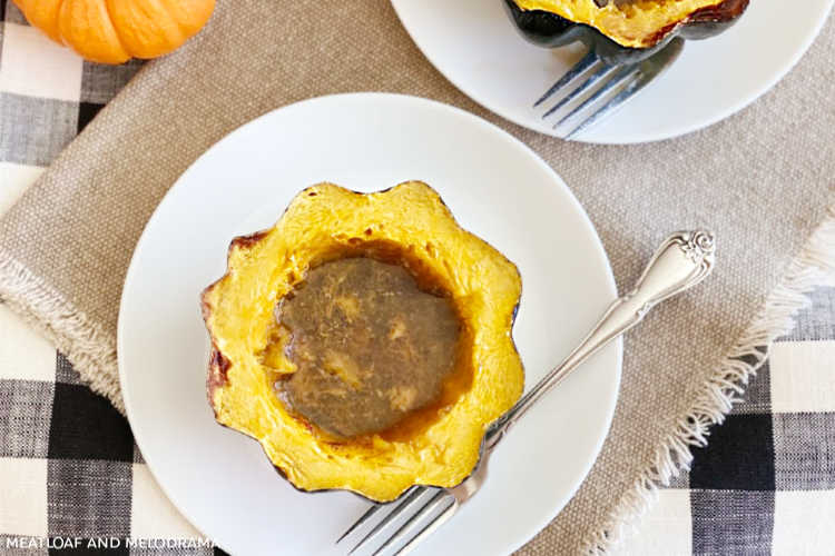 baked acorn squash with brown sugar and maple syrup on plate