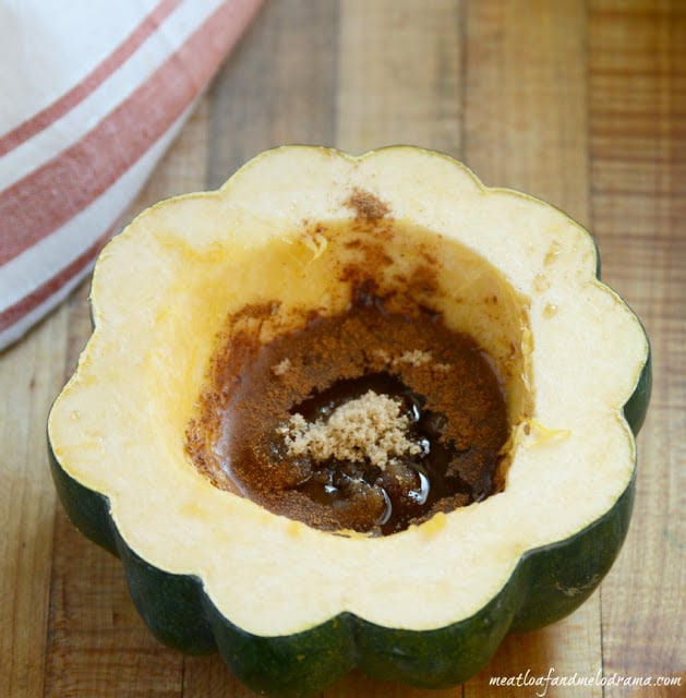 uncooked acorn squash with maple, brown sugar and cinnamon